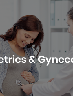 A pregnant woman smiles as a healthcare professional in a white coat uses a stethoscope to check her abdomen, symbolizing obstetrics and gynecology care.