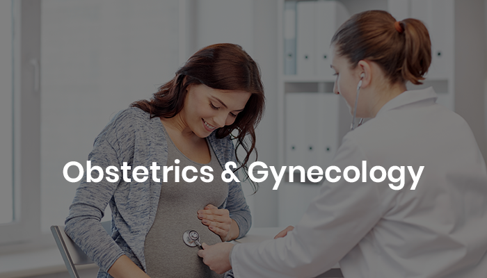 A pregnant woman smiles as a healthcare professional in a white coat uses a stethoscope to check her abdomen, symbolizing obstetrics and gynecology care.